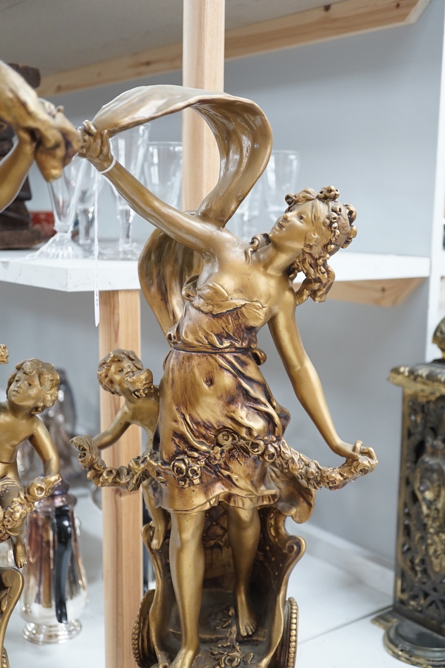 A pair of gilt spelter groups of a classical maiden and cherub, 61cm tall